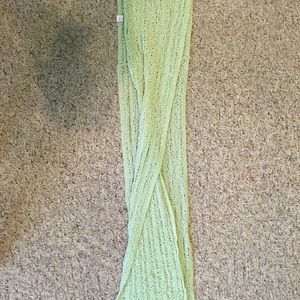 Green, knitted style scarf.